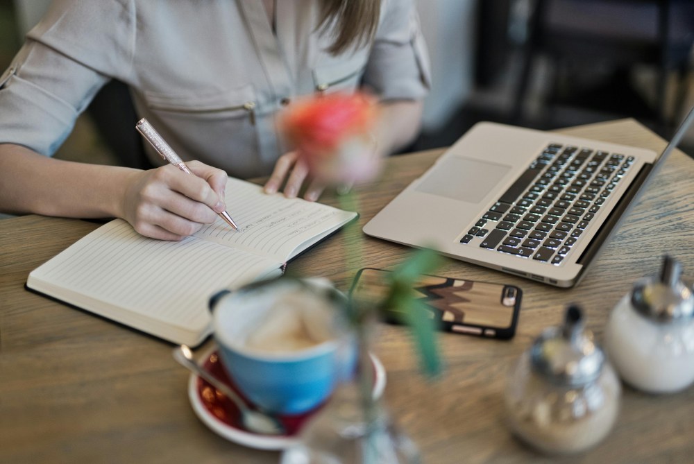A woman writing at her desk