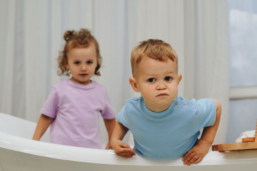 Two children wearing solid-colored T-shirts