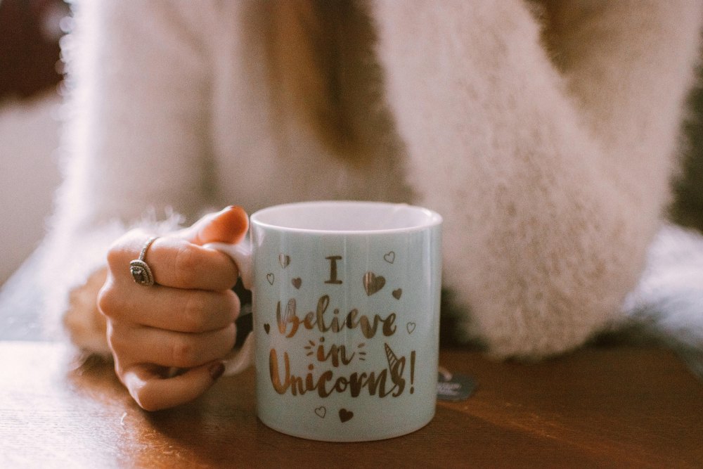 A woman is holding a coffee mug